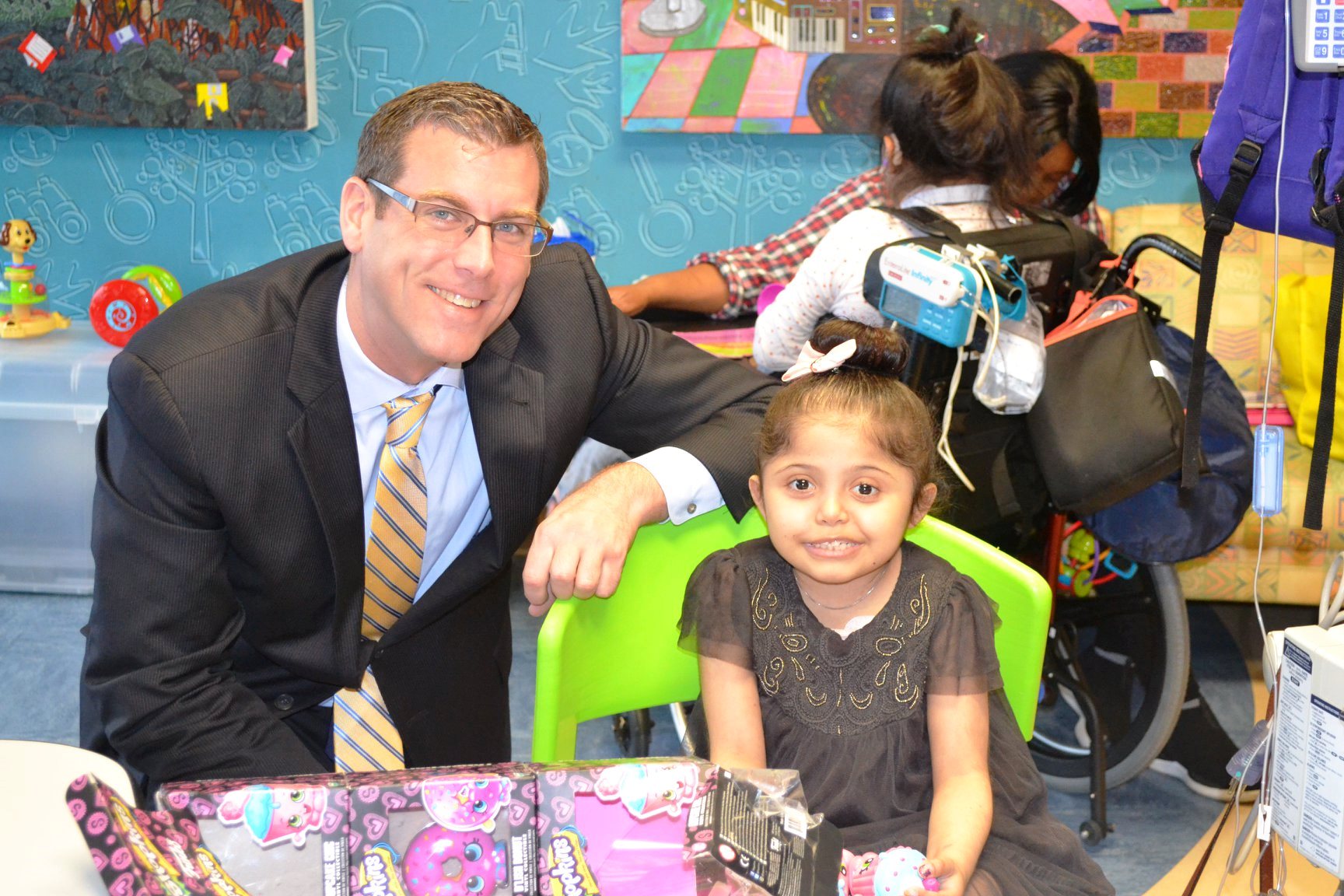 Assemblyman Braunstein is pictured distributing toys to children at St. Mary's Hospital for Children.