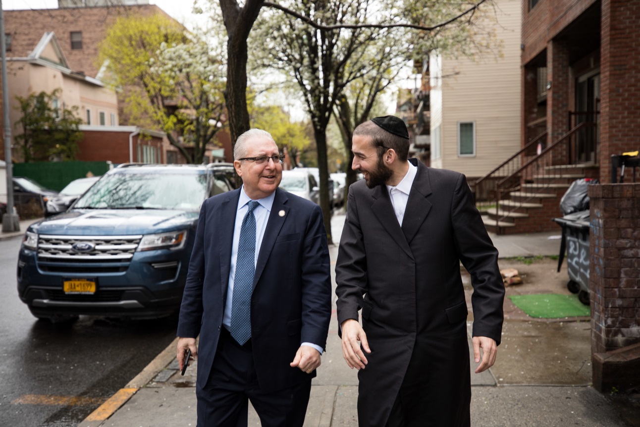 Assembly Member Simcha Eichenstein and Assembly Housing Chair Steven Cymbrowitz walk down 44th street in the Borough Park neighborhood of the Brooklyn borough of New York City on Monday, April 15.