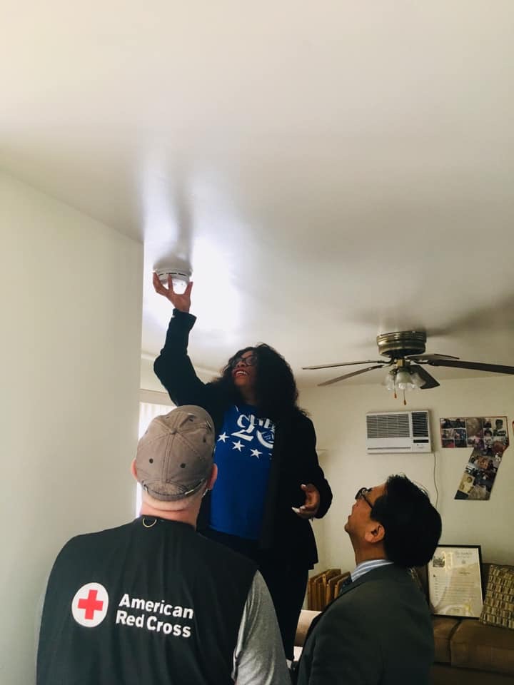 Assemblywoman Jean-Pierre is pictured installing a smoke alarm at the home of a Wyandanch resident.