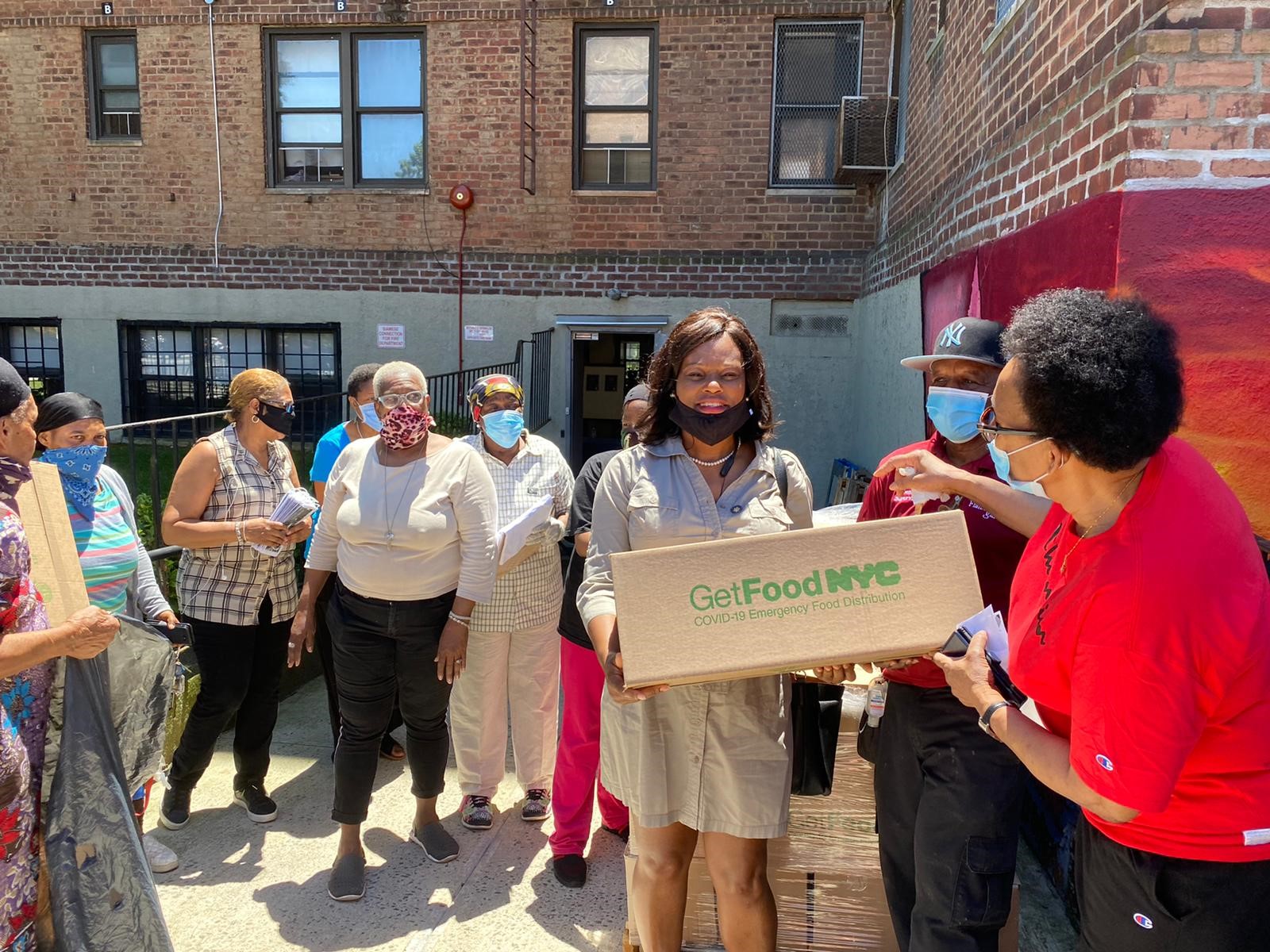 Assemblymember Rodneyse Bichotte and other community members gather together for a food distribution at the Flatbush Garden Community Center on June 12, 2020.