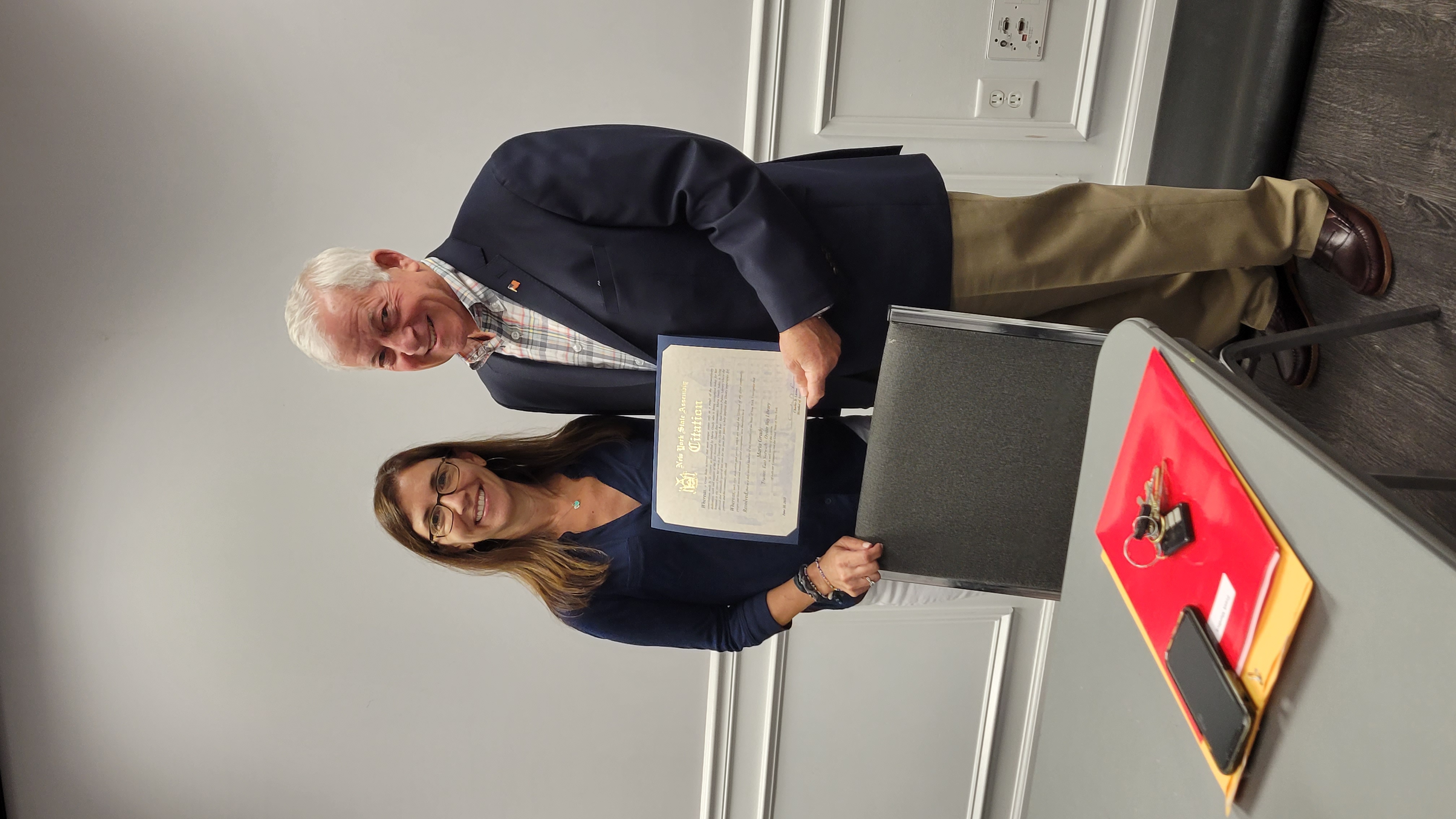 Assemblymember Lavine presents a citation to Maria Grady as she retires from her term as a Trustee of the Oyster Bay-East Norwich Public Library. For the past 5 years Maria has devoted her time to hel