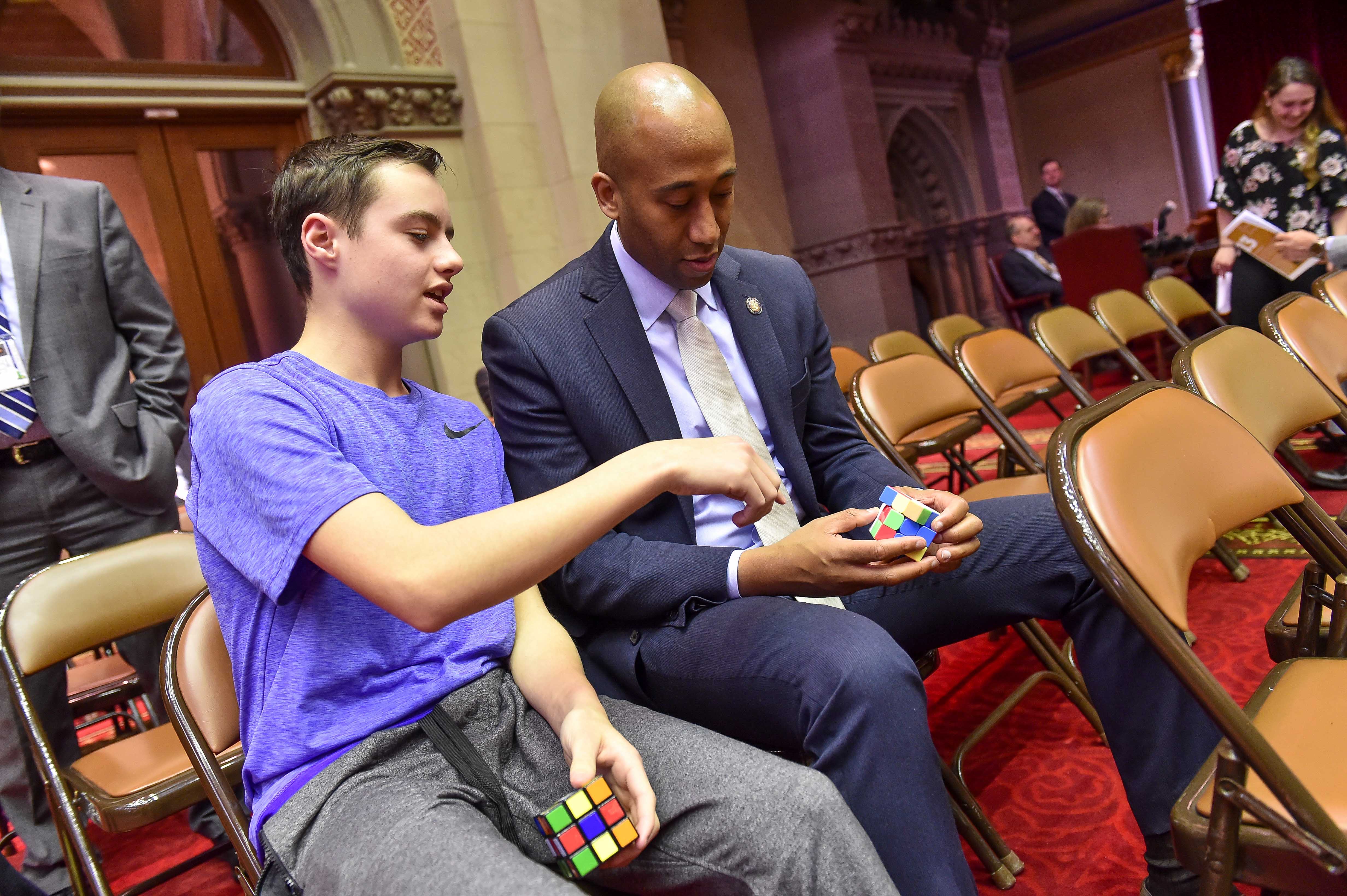 Assembly member Vanel bonding over Rubik’s cubes
