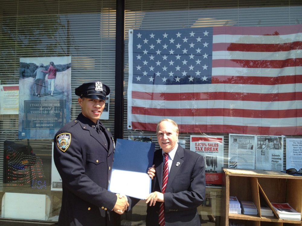 Assemblymember Colton recognizing police officer for outstanding service to protect the neighborhood.