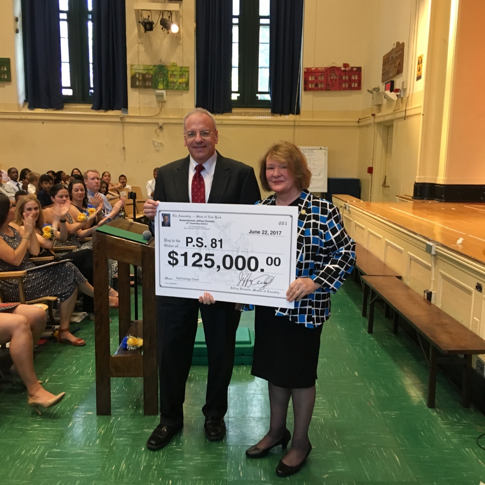 Assemblyman Dinowitz attending the June 22nd Graduation Ceremony of PS 81 pictured here presenting Principal Anna Kirrane with a technology grant check for $125,000.