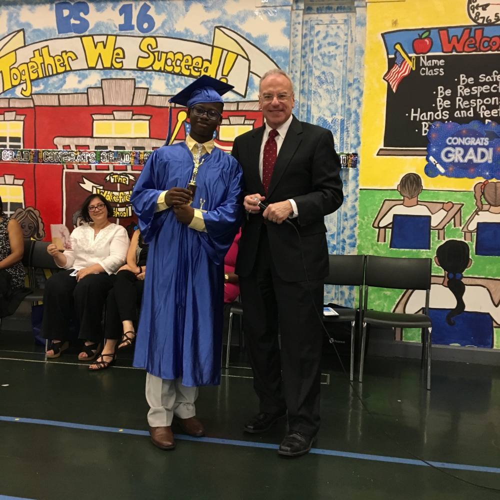 Assemblyman Dinowitz attending the June 22nd Graduation Ceremony of PS 16 pictured presenting the Community Service Award to Jair Joseph.