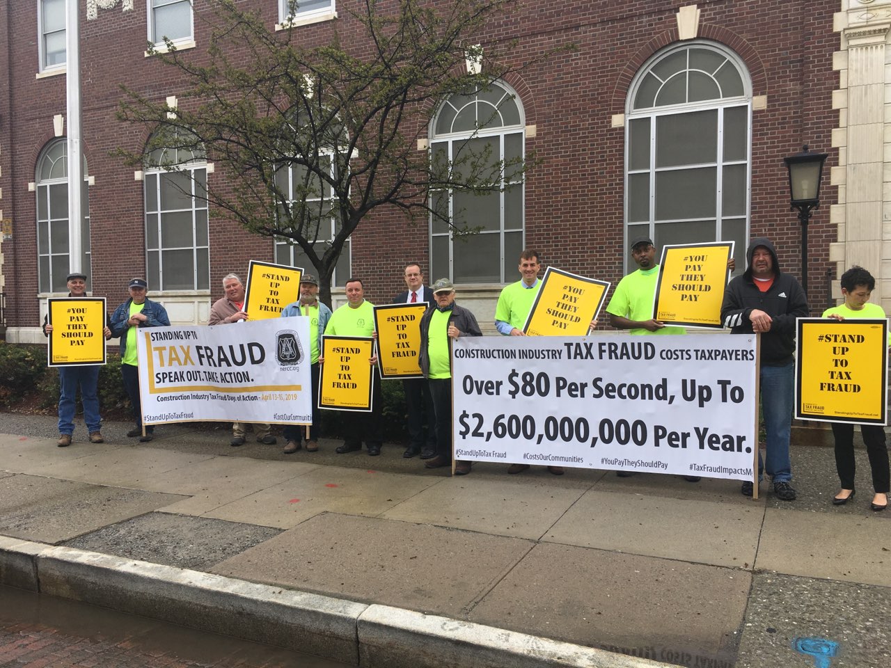 Assemblyman Karl Brabenec (R,C,I-Deerpark) [fifth from left] joins local officials and labor leaders for a rally to prevent wage theft and tax fraud in front of the Newburgh Post Office on Monday, Apr