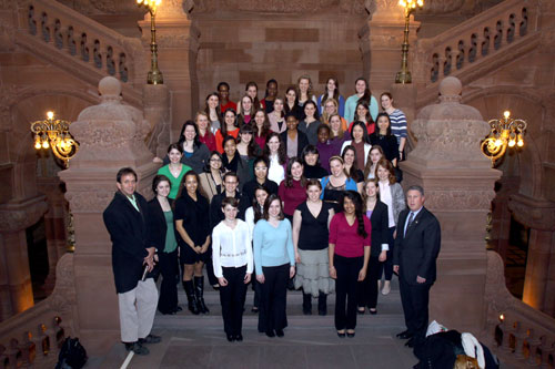 Assemblymember John McDonald welcomes members of Cornell University Women's Choir group to the Capitol at the Million Dollar Staircase prior to their tour.