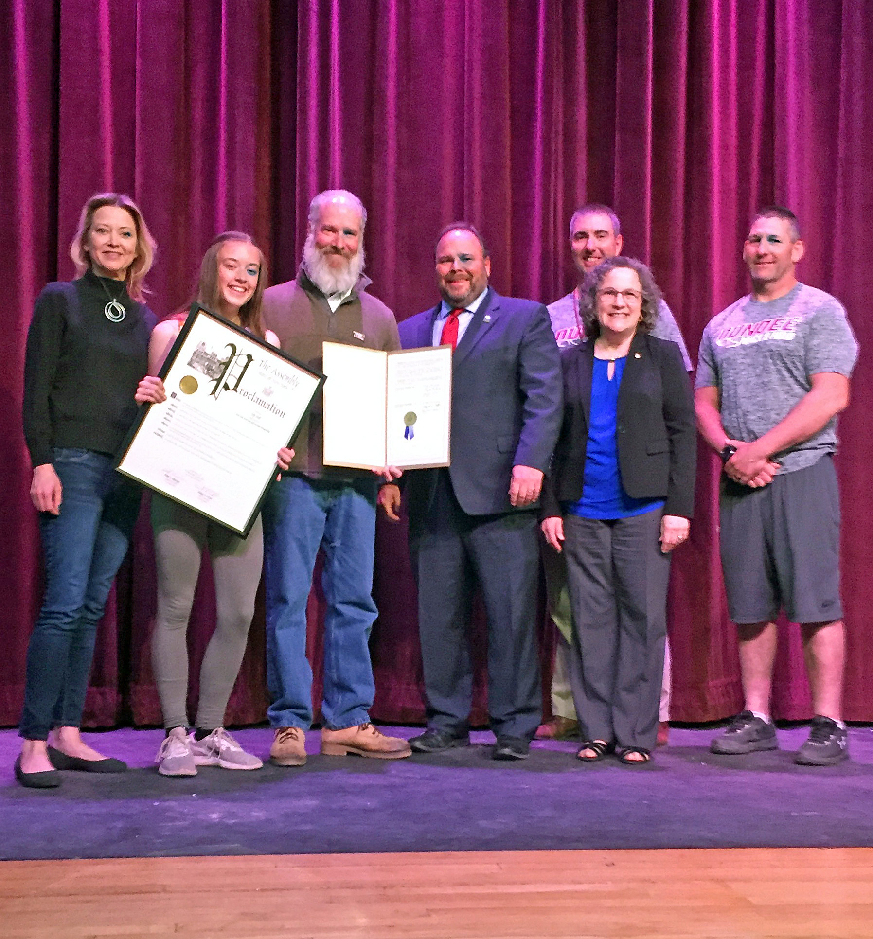 From left to right: Macy Hall, Lily’s mother, Lily, Lily’s father William Hall, Assemblyman Palmesano, Varsity Boys’ Track Coach Scott Shepardson, Sharon Sitrin-Moore, and Varsity Girls