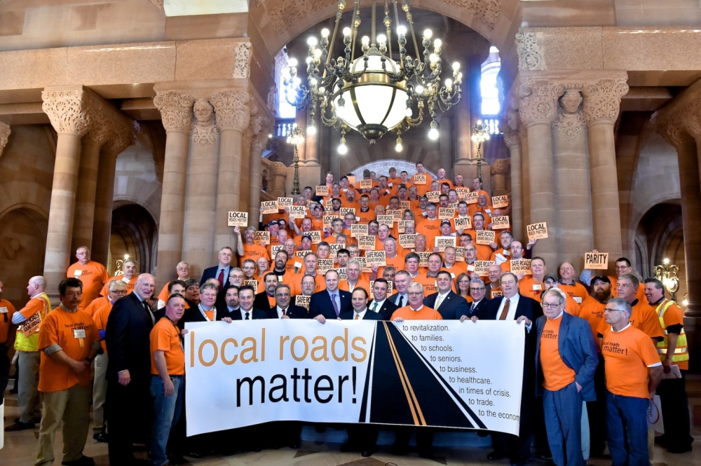 Members of the Assembly and Senate stand with town and highway workers to support funding for local roads