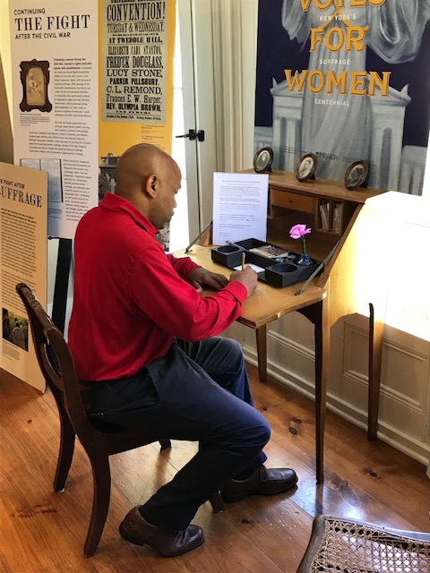 Speaker Heastie is pictured in the second photo sitting at the desk Matilda Joslyn Gage used when directing the operations of the National Woman Sufferage Association.